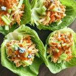 - 2 cups cooked chicken, shredded - 1/2 cup buffalo sauce (adjust according to your spice preference) - 1/4 cup cream cheese, softened at room temperature - 1/4 cup ranch dressing - 1 celery stalk, finely chopped - 1 medium carrot, shredded - 1/4 cup green onions, chopped (white and green parts) - 1 head of Romaine lettuce, leaves carefully separated - Optional: crumbled blue cheese for garnish You can easily swap ingredients in this recipe. If you want less spice, use mild buffalo sauce. You can also use Greek yogurt instead of cream cheese for a lighter option. If you don’t have ranch dressing, try using a yogurt-based dressing or a zesty vinaigrette. For those who don’t eat chicken, try shredded turkey or even canned tuna as a protein base. This dish is low in carbs and high in protein. Each serving packs a punch with flavor and nutrition. A single wrap contains about 200 calories, depending on your specific ingredients. The chicken offers protein, while the veggies provide fiber and vitamins. The ranch dressing and cream cheese add some fat, making the dish creamy and satisfying. If you want to boost the health factor, consider adding more veggies or using a whole grain wrap instead of lettuce. For more details, check the Full Recipe. Start by gathering your ingredients. You need cooked chicken, buffalo sauce, cream cheese, ranch dressing, celery, carrot, green onions, and Romaine lettuce. This prep takes just a few minutes. Make sure to have a clean workspace. 1. In a medium bowl, add the shredded chicken. Pour the buffalo sauce over it. Mix well. Use a fork to coat every piece in sauce. 2. Next, add the softened cream cheese. Blend it into the chicken. Keep mixing until it is smooth. Break up any lumps of cream cheese. 3. Now, add the ranch dressing, chopped celery, shredded carrot, and green onions. Stir everything together. You want a colorful and tasty mixture. 1. Take a strong Romaine lettuce leaf. This will hold your filling well. 2. Spoon a good amount of the buffalo chicken mixture into the leaf. Let it overflow a bit for a hearty bite. 3. If you like, sprinkle crumbled blue cheese on top. This adds great flavor. 4. Carefully fold the sides of the lettuce leaf around the filling. Think of it like a taco. 5. Enjoy your wraps right away for the best taste. Follow these steps, and you’ll have a fun meal ready in no time! For the complete recipe, check out the Full Recipe section. When making buffalo chicken lettuce wraps, avoid using too much buffalo sauce. This can make the filling soggy. Also, be careful not to overmix the chicken and cream cheese. You want the cream cheese to blend smoothly, but don’t turn it into a paste. Lastly, choose strong Romaine leaves. If they tear, your wraps will fall apart. To spice up your wraps, add more buffalo sauce. You can also include hot sauce for an extra kick. If you want to tone it down, use less buffalo sauce. Mixing in more cream cheese can help cool the heat. You can also use a milder ranch dressing. Make your wraps look great by arranging them on a colorful platter. Garnish with chopped green onions or carrot shavings. This adds a pop of color. Serve them with extra ranch dressing on the side for dipping. This makes for a fun and interactive meal. For the full recipe, check out the detailed steps provided earlier. {{image_4}} If you want to switch things up, try different proteins. Ground turkey makes a great substitute. It cooks quickly and absorbs flavors well. Shredded pork also works nicely; it adds a sweet, smoky taste. For a lighter option, use grilled shrimp or fish. Each choice brings its own unique flavor and texture. You can easily make this dish vegetarian or vegan. Swap the chicken for chickpeas or lentils. These ingredients are high in protein and add a hearty feel. For a vegan twist, use cashew cream instead of cream cheese. You can also choose plant-based ranch dressing. These changes keep the wraps tasty and satisfying. Experiment with different sauces and dressings to change the flavor. Try using barbecue sauce for a sweet and tangy twist. Sriracha adds heat, while teriyaki brings a hint of sweetness. You can also mix buffalo sauce with honey for a spicy-sweet version. Each sauce will give your wraps a new life and a fun taste adventure! For the full recipe, check out the detailed instructions above. To store leftover buffalo chicken lettuce wraps, first let them cool. Then, place them in an airtight container. You can keep them in the fridge for up to three days. If you have extra filling, store that separately. This keeps the lettuce fresh and crisp. When you’re ready to eat, take out the filling. Reheat it in a microwave-safe dish. Heat it for about one to two minutes, stirring halfway. Make sure it’s hot all the way through. Avoid reheating the lettuce. It’s best fresh and crisp. You can freeze the buffalo chicken filling, but not the lettuce. To freeze, place the filling in a freezer-safe container. It can last for up to three months. When you’re ready to use it, thaw it in the fridge overnight. Then, reheat it before serving with fresh lettuce. This keeps your meal tasty and enjoyable. For the full recipe, check out the detailed instructions above. Yes, you can make Buffalo Chicken Lettuce Wraps ahead of time. Prepare the filling early and store it in the fridge. The chicken mixture stays tasty for up to three days. Just keep the lettuce separate until you're ready to eat. This way, the wraps stay crisp. Buffalo Chicken Lettuce Wraps pair well with many sides. Here are some great options: - Fresh veggie sticks, like carrots and celery - A side salad with a light dressing - Sweet potato fries for a fun twist - Extra ranch dressing for dipping These sides add color and flavor and make your meal complete. You can easily adjust the spice level in this recipe. Start with less buffalo sauce if you prefer a milder taste. Add more sauce gradually until you find your perfect heat. You can also mix in some honey or sugar to balance out the heat. For extra spice, try adding hot sauce or diced jalapeños to the filling. Enjoy experimenting to create your ideal flavor! For the complete recipe, check out the Full Recipe. Buffalo chicken lettuce wraps are tasty, fun, and easy to make. We covered the key ingredients, steps to cook, and helpful tips. I shared how to avoid common mistakes and presented options for different diets. You can store leftovers and even customize the spice level. Remember, these wraps can fit any meal. Enjoy experimenting with your own twists! Happy cooking!