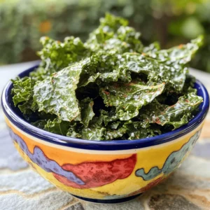 To make crispy kale chips, start with fresh kale. Look for kale that is bright green and free from brown spots. You will need one bunch of kale. Remove the tough stems and tear the leaves into bite-sized pieces. This helps them bake evenly and get nice and crispy. Next, you will need some olive oil and seasonings. Use two tablespoons of high-quality olive oil. This adds flavor and helps the kale crisp up nicely. For seasoning, you will need: - 1 teaspoon of garlic powder - 1 teaspoon of smoked paprika - Sea salt, to taste - Freshly cracked pepper, to taste These spices give the kale chips a tasty kick. Feel free to add more or less based on your taste. If you want a cheesy flavor, consider adding nutritional yeast. Use one teaspoon as an optional ingredient. It adds a nice flavor boost and is great for those who want a plant-based option. You can also experiment with other spices or herbs to make the chips your own. Follow the [Full Recipe] for a step-by-step guide to making these tasty snacks. Start with a bunch of fresh kale. Remove the tough stems. Tear the leaves into bite-sized pieces. Rinse them well under cool water. This step removes dirt and any grit. Drain the kale thoroughly using a salad spinner or by patting it dry with a clean towel. Dry leaves help achieve crispiness. In a large mixing bowl, add the torn kale. Drizzle two tablespoons of olive oil over it. Next, sprinkle one teaspoon of garlic powder and smoked paprika. If you like a cheesy taste, add one teaspoon of nutritional yeast. Season with sea salt and freshly cracked pepper to your liking. Use clean hands to massage the kale gently for about two to three minutes. This helps the flavors blend well and softens the leaves. Preheat your oven to 350°F (175°C). Line a baking sheet with parchment paper. Spread the seasoned kale evenly on the sheet. Make sure the leaves are not overlapping. This ensures they bake evenly and become crisp. Bake for 10 to 15 minutes, checking often. The edges should turn crispy and slightly brown. Once they are done, let the chips cool on the baking sheet. They will become crunchier as they cool. Taste the chips and adjust seasoning if needed. Enjoy your crispy kale chips as a healthy snack or garnish! You can find the full recipe [here](#). To get the best crispiness from your kale chips, follow a few key steps. First, make sure your kale is very dry. Any water left on the leaves can lead to soggy chips. After washing, use a salad spinner or carefully pat the leaves dry with a towel. Next, don't overcrowd the baking sheet. Spread the kale pieces out in a single layer. This allows hot air to circulate around each leaf, creating that perfect crunch. If your batch is big, split it into two sheets. When it comes to seasoning, less is more. Start with a light drizzle of olive oil. Too much oil can make the chips greasy. I usually use about two tablespoons for one bunch of kale. Sprinkle your spices evenly. I like using garlic powder and smoked paprika. They add great flavor without being overpowering. You can mix the seasonings in a bowl before adding them to the kale for even coverage. One common mistake is baking at too high a temperature. Keep your oven at 350°F (175°C). Baking at a higher heat can brown the chips too quickly, leading to burnt edges. Another mistake is not keeping an eye on the kale as it bakes. Check them around the 10-minute mark. The chips can go from perfect to burnt in just a minute. Finally, avoid using kale that is wilted or brown. Fresh, vibrant leaves will give you the best results. For more details on making these tasty snacks, refer to the Full Recipe. {{image_4}} You can make your kale chips even more fun by trying different flavors. Here are a few ideas: - Spicy: Add cayenne pepper or chili powder for heat. Start with a small amount and taste it. - Cheesy: Use nutritional yeast for a cheesy taste. It adds great flavor without dairy. - Sweet: Try a sprinkle of cinnamon and a bit of maple syrup. This gives a nice twist. Mix and match these flavors to find your favorite! You can cook kale chips in different ways. Here are some options: - Air Fryer: Set your air fryer to 300°F (150°C) and cook for about 5-7 minutes. Check often to avoid burning. - Dehydrator: This method takes longer but keeps the nutrients. Set it to 125°F (52°C) for 1-2 hours. Each method gives a unique texture and flavor. You can experiment to see which you like best! Kale chips are great on their own, but you can add some flair: - Serve them in a bright bowl for a fun look. - Pair them with dips like hummus or guacamole for extra flavor. - Use them as a garnish on soups or salads. Feel free to get creative! You can use these ideas to make your kale chips stand out at your next snack time. For the full recipe, check out the Kale Crunchies section above. To keep your homemade kale chips fresh, let them cool completely. Once cool, place them in a container. You can use a jar, a zip-top bag, or a food storage container. Make sure to seal the container tightly to keep air out. Air can make your chips lose their crispness. Homemade kale chips can last about 5 to 7 days. After that, they may become stale. For the best taste, eat them within the first few days. If you store them well, you can enjoy their crunchy goodness for a week. Choose containers that are airtight. Glass jars work well and look nice on your shelf. Zip-top bags are also great, especially if you want to take them on the go. Just remember to squeeze out as much air as you can before sealing. This helps keep your kale chips crispy longer. For the full recipe of crispy kale chips, check out the detailed instructions above! To make crispy kale chips, follow these steps. First, preheat your oven to 350°F (175°C). Line a baking sheet with parchment paper. Next, tear the kale leaves into bite-sized pieces and place them in a bowl. Add 2 tablespoons of olive oil, 1 teaspoon of garlic powder, 1 teaspoon of smoked paprika, and optional nutritional yeast for a cheesy flavor. Season with sea salt and pepper. Now, massage the kale with your hands for 2-3 minutes. This helps the leaves absorb the oil and spices. Spread the kale on the baking sheet in a single layer. Bake for 10-15 minutes. Keep a close eye on them to avoid burning. The edges should turn crispy and slightly brown. Let them cool for a few minutes before enjoying. This method gives you a tasty and healthy snack. Yes, kale chips are healthy! They are low in calories and high in nutrients. Kale is packed with vitamins A, C, and K. It also has fiber and antioxidants. When you make them at home, you control the oil and salt. This allows you to make a healthier snack than most store-bought options. Kale chips are a great way to enjoy greens. They satisfy your crunch cravings without the guilt. Plus, they are a good source of plant-based nutrients. Eating kale chips can help you feel full and happy. Yes, you can buy ready-made kale chips. Many stores offer them in various flavors. However, check the ingredient list. Some brands add preservatives or extra salt. Homemade kale chips allow you to use fresh ingredients and control the flavor. If you're short on time, store-bought chips can be a quick option. But, for the best taste and health benefits, I recommend making your own. For the full recipe, refer back to the recipe section. This blog post covered how to make great kale chips. We looked at fresh kale, olive oil, and seasonings. I shared steps to prepare, season, and bake for crispness. You learned tips for maximum crunch and common mistakes. We explored tasty flavor variations and cooking methods. Lastly, I provided storage tips to keep your chips fresh. Kale chips are easy and fun to make. With these steps, you can enjoy them anytime. Enjoy your crispy, healthy snack!