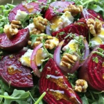 To create this vibrant Roasted Beet and Goat Cheese Salad, you’ll need the following fresh ingredients: - 4 medium-sized beets, with tops removed - 2 cups fresh arugula or a mix of vibrant salad greens - 1/2 cup creamy goat cheese, crumbled - 1/4 cup walnuts, toasted and coarsely chopped - 1/4 red onion, sliced thinly - 3 tablespoons extra virgin olive oil - 2 tablespoons balsamic vinegar - 1 tablespoon honey - Salt and freshly ground black pepper to taste Each ingredient plays an important role in this salad. The beets bring a lovely earthy flavor and bright color. The arugula adds a peppery taste, while the goat cheese offers a creamy richness. Walnuts add crunch, and red onion gives a sharp bite. The honey vinaigrette ties it all together, creating a flavor burst that you’ll love. For the full recipe, including step-by-step instructions, check out the [Full Recipe]. - Set oven to 400°F (200°C). - Wrap beets in aluminum foil, drizzle olive oil, and sprinkle with salt. - Place on a baking sheet and roast for 45-60 minutes. - Cool, peel, and cut beets into wedges. - Combine olive oil, balsamic vinegar, honey, salt, and pepper. - Whisk until smooth. - In a large bowl, add greens, beet wedges, red onion, and walnuts. - Drizzle vinaigrette over the salad and toss gently. - Transfer salad to a serving platter, sprinkle goat cheese, and serve fresh. For the full recipe, check out the details above. Enjoy this salad! - Serve in a shallow bowl to highlight colors. - Garnish with mint or parsley sprigs for a fresh touch. When you present this salad, think about how to show off those rich colors. The deep reds of the beets contrast beautifully with the green arugula. A shallow bowl works best to let these colors shine. Adding fresh mint or parsley not only looks pretty but also adds a nice aroma. - Alternative greens: Spinach or kale for a different taste. - Use feta cheese instead of goat cheese if you prefer. If you can’t find arugula, spinach or kale are great choices. They bring their own flavor and nutrition. Feta cheese gives a tangy taste that works well too. Feel free to mix and match based on what you have at home. - Add fresh herbs like dill or basil for extra zest. - Incorporate roasted cherry tomatoes for added flavor. To take this salad up a notch, fresh herbs can make a big difference. Dill or basil adds depth and freshness. Roasted cherry tomatoes bring a sweet burst that complements the beets perfectly. Try these options for a unique twist on the classic dish. {{image_4}} You can change up your salad based on the seasons. One fun way is to add seasonal fruits. Slices of pears or apples bring a sweet crunch. They balance the earthiness of the beets and cheese. Another great option is to toss in roasted pumpkin seeds. They add a tasty crunch and healthy fats. You can use these seeds in the fall for a cozy touch. If you want to make this salad vegan, it's simple! Just leave out the goat cheese. Instead, try using agave syrup in the dressing. This sweetener keeps the flavor bright and fresh. For those needing gluten-free options, check your dressings. Make sure they are certified gluten-free. This way, everyone can enjoy the salad without worry. These variations keep your Roasted Beet and Goat Cheese Salad lively and fun. You can always explore new flavors while enjoying this classic dish. - Keep in an airtight container in the fridge for up to 3 days. - Separate dressing from salad for longer freshness. This helps maintain the crispness of the greens and the creaminess of the cheese. - Best enjoyed cold; avoid reheating due to texture changes. The beets may become mushy, and the salad will lose its fresh taste. Instead, serve it chilled straight from the fridge for a delightful crunch! Yes, prepare the components and assemble just before serving. This keeps the greens fresh. Beets are rich in fiber, vitamins, and minerals. They are good for heart health, too. They should be tender enough to easily pierce with a fork. If they resist, roast longer. Yes, grilled chicken or quinoa makes great additions. Both options add flavor and nutrition. Honey vinaigrette complements the flavors well. You could also use a lemon vinaigrette for a twist. Roasted Beet and Goat Cheese Salad is a delightful dish. It mixes vibrant colors and flavors. Here is the full recipe for you to enjoy. Ingredients: - 4 medium-sized beets, with tops removed - 2 cups fresh arugula or a mix of vibrant salad greens - 1/2 cup creamy goat cheese, crumbled - 1/4 cup walnuts, toasted and coarsely chopped - 1/4 red onion, sliced thinly - 3 tablespoons extra virgin olive oil - 2 tablespoons balsamic vinegar - 1 tablespoon honey - Salt and freshly ground black pepper to taste Instructions: 1. Preheat Oven: Set your oven to 400°F (200°C). This heats up for the beets. 2. Prepare Beets: Wrap each beet in aluminum foil. Drizzle olive oil and sprinkle salt on them. Place them on a baking sheet for easy handling. 3. Roasting Beets: Put the baking sheet in the oven. Roast for about 45-60 minutes. They should be tender and easy to pierce with a fork. After roasting, let them cool. Then, peel off the skins and cut them into wedges. 4. Make Vinaigrette: In a small bowl, mix olive oil, balsamic vinegar, honey, salt, and pepper. Whisk until smooth and set aside. 5. Combine Salad Ingredients: In a large bowl, add arugula or mixed greens, roasted beet wedges, red onion, and walnuts. 6. Dress the Salad: Drizzle the honey vinaigrette over the salad mix. Toss gently, coating everything well. 7. Plate the Salad: Transfer the salad to a serving platter or individual plates. Sprinkle the crumbled goat cheese on top. 8. Serve and Enjoy: This salad shines when served fresh. Enjoy the burst of colorful flavors! Prep time is just 15 minutes, and total time is about 1 hour and 15 minutes. This recipe serves four people. Presentation Tips: Serve in a large, shallow bowl. This highlights the salad’s vibrant colors. For a fresh touch, add mint or parsley sprigs. You can drizzle a little honey on top for extra sweetness. In this post, we explored how to create a delicious Roasted Beet and Goat Cheese Salad. You learned about the fresh ingredients, step-by-step instructions, and helpful tips to make it shine. Remember, you can easily customize this salad with seasonal fruits or dietary alternatives. It's not only tasty but also nutritious. Enjoy this vibrant dish as a meal or a side. Make it your own, and share it with family and friends next time!