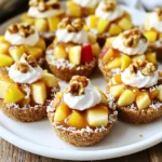 - 1 cup graham cracker crumbs - 1/4 cup unsweetened shredded coconut - 1/2 teaspoon ground cinnamon - 1/4 cup melted coconut oil - 2 medium apples, diced - 1/2 cup caramel sauce - 1 tablespoon fresh lemon juice - 1/4 cup chopped walnuts (optional) - Whipped cream for serving (optional) To make No-Bake Caramel Apple Pie Bites, you need simple ingredients. The graham cracker crumbs form the crust. The shredded coconut adds texture and flavor. Ground cinnamon gives warmth to the bites. Melted coconut oil helps bind the crust. You can choose any two apples you like. Dicing them makes them easy to eat. The caramel sauce provides that sweet, sticky goodness. Fresh lemon juice keeps the apples bright and fresh. If you want, add chopped walnuts for crunch. Finally, whipped cream makes a nice touch on top. Gather these ingredients before you start. This makes the process smooth and fun! Start with a mixing bowl. Combine the graham cracker crumbs, shredded coconut, ground cinnamon, and melted coconut oil. Mix these well. You want a texture that looks like wet sand. This consistency helps the bites hold together. Next, line your muffin cups with parchment paper. This step makes it easy to take the bites out later. Take about 1 tablespoon of your crust mixture. Press it down firmly into the bottom of each cup. Make sure it is compact for the best support. Now, let’s prepare the filling. In another bowl, toss the diced apples with lemon juice and half of the caramel sauce. Coat the apple pieces evenly. Then, spoon this caramel apple filling into the crusts. Fill them just below the rim to avoid any overflow. Finally, drizzle the remaining caramel sauce over the top of each bite. If you like, add chopped walnuts for some crunch. Let the tray chill in the refrigerator for at least 30 minutes. This helps the bites set properly. Once set, carefully remove them from the molds. Serve them chilled, and enjoy! When you make No-Bake Caramel Apple Pie Bites, a solid crust is key. Here are some tips to help: - Compact Crusts: Make sure to press the graham cracker mixture firmly into the molds. This makes the crust strong enough to hold the filling. Think of it like packing a snowball; you want it tight! - Silicone Molds: I love using silicone molds for these bites. They let the bites pop out easily. If you use metal pans, you may need to run a knife around the edges. You can make these bites your own with fun twists: - Flavored Caramel Sauces: Try different caramel sauces for a unique touch. Salted caramel adds a nice kick. You can even use chocolate or butterscotch sauces if you want to mix it up. - Spice Variations: Add spices to the crust or apple filling for extra flavor. Nutmeg or ginger can bring warmth. You can also try a pinch of allspice for a little zing. These tips will help you create tasty and fun No-Bake Caramel Apple Pie Bites! {{image_4}} You can easily switch up the flavors in your No-Bake Caramel Apple Pie Bites. Here are some fun ideas: - Apple Varieties: You can use different types of apples for unique tastes. Try tart Granny Smith apples for a crisp bite or sweet Fuji apples for a milder flavor. Each variety will change the taste and texture. - Nuts and Toppings: Feel free to mix in other nuts. Chopped pecans or almonds can add a nice crunch. You can also sprinkle some chocolate chips on top for a sweet twist. I love making recipes that everyone can enjoy. Here are some easy swaps for different diets: - Vegan Option: You can replace the caramel sauce with a vegan alternative. Look for plant-based caramel made from coconut milk or dates. Use coconut oil for the crust, and you’ll have a tasty vegan treat. - Gluten-Free Choice: If you need a gluten-free version, swap the graham cracker crumbs for gluten-free crumbs. Many brands offer gluten-free graham crackers or you can make your own from nuts and oats. These variations let you personalize your bites to fit different tastes and dietary needs. Enjoy creating these delicious treats! To keep your No-Bake Caramel Apple Pie Bites fresh, store them in the refrigerator. Use airtight containers to lock in moisture and maintain their tasty texture. Doing this helps prevent the bites from getting soggy or losing their crunch. If you want to save some bites for later, you can freeze them. First, let the bites chill in the fridge for at least 30 minutes. Then, place them in a freezer-safe container. When you want to enjoy them, take out what you need and let them thaw in the fridge. Be ready to adjust the chilling time. They may need a little longer to set again before serving. No-Bake Caramel Apple Pie Bites last about three days in the fridge. Keep them in an airtight container to keep them fresh. If you notice any change in smell or texture, it's best to toss them. Look for signs like discoloration or a crust that feels too soft. Yes, you can make these bites a day ahead. Just prepare and chill them in the fridge. This way, they will be ready for your party or gathering. They taste great cold and are easy to grab. If you need a substitute for graham cracker crumbs, you can use crushed cookies or nuts. Almond flour or oat flour works well too. Each option gives a unique taste and texture, so feel free to get creative! You learned how to make tasty no-bake caramel apple pie bites. We covered each step, from mixing the crust to filling them with fresh apples. Remember, these bites can be customized with your favorite flavors. You can store them in the fridge or freeze them for later. Try different nut toppings or apple types to make your bites unique. Enjoy sharing these easy treats with friends and family. Your kitchen will become a hit with these simple recipes.