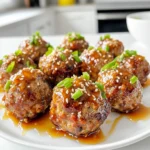 To make Air Fryer Honey Garlic Meatballs, you need a few simple ingredients that blend well together. Here’s what you’ll need: - 1 lb ground chicken or turkey - 1/2 cup breadcrumbs (preferably panko for added crispiness) - 1/4 cup grated Parmesan cheese - 1/4 cup chopped fresh parsley - 1 large egg - 2 cloves garlic, minced - 1 teaspoon salt - 1/2 teaspoon freshly cracked black pepper - 1/2 teaspoon garlic powder - 1 tablespoon soy sauce - 1/4 cup honey - 1 tablespoon rice vinegar - 1 teaspoon sesame oil - Sesame seeds and sliced green onions for garnish Each ingredient plays a role in bringing flavor and texture to the dish. For example, the breadcrumbs help bind the meatballs. They add a nice crunch, especially when using panko. The honey gives a sweet touch, while soy sauce adds depth. Don’t skip the garlic; it brings a savory note that makes these meatballs irresistible. Using fresh parsley not only adds color but also a fresh taste. The egg binds everything together, ensuring your meatballs hold their shape. Feel free to adjust the seasonings to match your taste. This recipe is versatile and can easily adapt to what you have on hand. Start by gathering all your ingredients. In a large bowl, mix the ground chicken or turkey with breadcrumbs, Parmesan cheese, chopped parsley, egg, minced garlic, salt, black pepper, and garlic powder. Use your hands to blend everything well until it forms a smooth mixture. Now, shape the mixture into meatballs. Aim for about 1 inch in size. Place them on a clean plate or tray. Make sure they are not touching each other. This helps them cook evenly later. Next, preheat your air fryer to 375°F (190°C). Preheating is key. It helps the meatballs cook right away and get that nice golden crust. Once preheated, arrange the meatballs in the air fryer basket. Lay them in a single layer. For a crispy finish, lightly spray them with cooking spray. Cook for about 12-15 minutes. Halfway through, shake the basket gently. This turns the meatballs and helps them brown nicely. To check for doneness, use a meat thermometer. The internal temperature should hit 165°F (75°C) for safe eating. While the meatballs cook, it’s time to make the honey garlic sauce. In a small saucepan on medium heat, whisk together honey, soy sauce, rice vinegar, and sesame oil. Let this simmer for 3-5 minutes. Keep stirring until it thickens slightly and bubbles form. You want the sauce to be sticky but not too thick. It should coat the meatballs perfectly when you drizzle it on later. To keep your meatballs juicy, use fresh ingredients. Choose ground chicken or turkey with some fat. Fat helps maintain moisture during cooking. Mix in breadcrumbs, Parmesan, and parsley for extra flavor. The egg binds everything together. Don't overmix; this keeps the meatballs tender. A light spray of cooking oil helps create a crispy outer layer. Make sure to space out the meatballs in the air fryer. This allows hot air to circulate, cooking them evenly. Flip the basket halfway through cooking for even browning. You can add more flavor with simple seasonings. Try adding chili flakes for heat or ginger for a twist. Marinating the meatball mixture overnight can deepen the taste. Just cover and refrigerate the mixture to let the flavors blend. {{image_4}} You can switch up the ground meat for your honey garlic meatballs. Ground beef or pork works well. If you want a leaner option, try ground chicken or turkey. Each choice gives a different taste and texture. If you need a gluten-free option for breadcrumbs, use crushed gluten-free crackers. You can also use ground oats. Both alternatives hold the meatballs together nicely while keeping them tasty. To boost flavor, add spices like ginger or chili flakes. Ginger adds a warm, zesty kick, while chili flakes give some heat. You can adjust the amount based on your taste. You might also try different sauces. Instead of the honey garlic sauce, use teriyaki or sweet chili sauce. Each sauce brings a unique flavor to the meatballs, letting you explore new tastes. Pair your meatballs with sides for a complete meal. Steamed rice, quinoa, or roasted veggies work great. These sides complement the sweet and savory flavors of the meatballs. For a fun presentation at parties, serve the meatballs on a colorful platter. Use fresh parsley or greens as a base. You can also put toothpicks in each meatball for easy serving. This makes them perfect for gatherings or game days. To store leftover meatballs, let them cool first. Place them in an airtight container. This keeps them fresh and tasty. You can refrigerate them for up to three days. When ready to eat, simply reheat them in the air fryer or microwave. If you want to save meatballs for later, freezing is a great option. First, let them cool completely. Then, place them in a single layer on a baking sheet. Freeze them for about an hour. Once they are firm, transfer them to a freezer bag. Remove as much air as possible to prevent freezer burn. You can freeze them for up to three months. When you're ready to eat, take out the meatballs and reheat them. You can air fry them at 375°F (190°C) for about 10-12 minutes. They will heat through and regain their crispy texture. Properly stored, these meatballs will last in the fridge for three days. If frozen, they can last for up to three months. Always check for any signs of spoilage before eating. If they smell off or look strange, it's best to throw them away. Enjoy your delicious honey garlic meatballs while they are fresh! Yes, you can use other meats. Ground beef or pork works well too. If you want a healthier option, try ground lamb or even plant-based meat. Each will bring its own unique flavor. You can also mix meats for a fun twist. Check the internal temperature of the meatballs. They should reach 165°F (75°C) for safety. Use a meat thermometer for the best results. This temperature ensures they are cooked all the way through. If you don’t have a thermometer, cut one open and check for no pink inside. These meatballs pair great with many sides. Try serving them over rice or noodles for a filling meal. You can also add steamed vegetables for a colorful plate. For a lighter option, serve them with a fresh salad. They also make a great appetizer with toothpicks! Absolutely! You can prepare the meatball mixture the night before. Just cover it and store it in the fridge. When you're ready to cook, form the meatballs and air fry them. You can also cook them and store leftovers in the fridge for quick meals later. Reheat in the air fryer for the best results. In this post, we explored making delicious honey garlic meatballs. We covered essential ingredients, step-by-step instructions, and tips for juicy, crispy meatballs. You learned about variations and storage to keep them fresh. With these details, you can impress family and friends in the kitchen. Don't hesitate to experiment with flavors and sides to make this dish your own. Enjoy your cooking journey and happy eating!