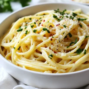 - 200g spaghetti - 3 tablespoons unsalted butter - 4 cloves garlic, minced - 1 cup heavy cream - 1 cup freshly grated Parmesan cheese - Salt and freshly cracked pepper to taste - 1 teaspoon Italian seasoning blend - Fresh parsley, finely chopped (for garnish) - Red pepper flakes (optional) These ingredients create a rich and tasty meal. The spaghetti serves as a base, while the butter and garlic add depth. Heavy cream makes the dish creamy, and Parmesan gives it a cheesy kick. If you want to change things up, consider these swaps: - Use whole wheat spaghetti for a healthier option. - Replace unsalted butter with olive oil for a lighter flavor. - Swap heavy cream for coconut cream if you want a dairy-free version. - Nutritional yeast can replace Parmesan for a vegan twist. These alternatives keep the dish exciting while catering to dietary needs. To make this creamy pasta, you need: - A large pot for boiling spaghetti - A large skillet for the sauce - A colander to drain the pasta - A spatula or wooden spoon for stirring - A measuring cup for cream and cheese - A knife and cutting board for garlic and parsley Having the right tools makes cooking easier and more fun. {{ingredient_image_2}} Start by filling a large pot with water. Bring it to a vigorous boil. Add a good amount of salt. This helps flavor the spaghetti. Toss in 200g of spaghetti. Cook it according to the package instructions, usually 8-10 minutes, until it is al dente. This means it should still have a bit of bite. Once cooked, drain the pasta in a colander. Remember to save about 1 cup of the pasta water for later. This water can help adjust the sauce's thickness. Now, grab a large skillet. Melt 3 tablespoons of unsalted butter over medium heat. When the butter is melted, add 4 cloves of minced garlic to the skillet. Sauté the garlic for 1-2 minutes. Stir frequently to keep it from burning. You want the garlic to be soft and fragrant, not brown. This step adds a rich flavor to the dish. Next, it’s time to create the creamy base. Slowly pour in 1 cup of heavy cream. Stir continuously to keep the mixture smooth. Bring the sauce to a gentle simmer. Let it bubble softly for about 3-4 minutes. This helps the sauce thicken and become rich. Now, add in 1 cup of freshly grated Parmesan cheese. Also, mix in 1 teaspoon of Italian seasoning, salt, and freshly cracked pepper to taste. Stir until the cheese melts completely, making a smooth and velvety sauce. Add the drained spaghetti to the skillet. Toss it gently in the sauce, ensuring every strand is well coated. If the sauce seems too thick, add some of the reserved pasta water. Mix it in bit by bit until you reach your desired creamy texture. Taste the dish and adjust the seasoning as you see fit. If you like a bit of heat, sprinkle in some red pepper flakes. Finally, serve the pasta hot, garnished with fresh parsley for a touch of color. To get a creamy texture in your pasta, focus on the sauce. Start with butter, then add garlic. Sauté the garlic gently until soft but not brown. Next, pour in the heavy cream. Stir often to keep it smooth. Let it simmer for a few minutes to thicken. When you mix in the cheese, it creates that rich, creamy feel. If the sauce is too thick, use the reserved pasta water. Adding a little at a time helps achieve the right consistency. One common mistake is cooking the garlic too long. If it browns, it can taste bitter. Another mistake is not saving enough pasta water. This water is starchy and helps your sauce cling to the spaghetti. Make sure to taste your dish before serving. Adjust the salt and pepper as needed. It's better to add a little at a time than to over-season. Lastly, don’t rush the melting of the cheese. Take your time for a smooth sauce. You can easily adapt this recipe for different diets. For a lighter version, swap heavy cream with half-and-half or a plant-based cream. If you need a gluten-free option, use gluten-free spaghetti. For a dairy-free version, look for vegan cheese and cream. You can also use olive oil instead of butter for a healthier fat. If you're vegan, skip the cheese and add nutritional yeast for a cheesy flavor. These swaps keep the dish tasty while meeting dietary needs. Pro Tips Use Fresh Ingredients: Always opt for fresh garlic and high-quality Parmesan cheese. Fresh ingredients will elevate the flavor of your dish significantly. Don’t Skip the Pasta Water: Reserving pasta cooking water is key for achieving the perfect sauce consistency. It helps to emulsify the sauce and ensures it clings beautifully to the spaghetti. Control the Heat: When sautéing garlic, keep the heat on medium to avoid burning. Burnt garlic can add a bitter taste to your dish. Experiment with Flavors: Feel free to customize your sauce by adding other herbs or spices, such as basil or oregano, to suit your taste preferences. {{image_4}} You can easily add vegetables to your creamy garlic Parmesan spaghetti. Spinach adds color and nutrients. Just toss in a handful of fresh spinach while cooking the sauce. It wilts down quickly and blends well. Mushrooms bring a rich, earthy flavor. Sauté sliced mushrooms in the butter before adding garlic. This step enhances their taste and adds depth to the dish. Want to make your meal heartier? Add protein like chicken or shrimp. For chicken, cook diced pieces in the skillet until golden. Then, follow the recipe as usual. For shrimp, add them just before the cream. Cook until they turn pink. This method keeps them tender and juicy. Both options make the dish more filling and satisfying. You can change the flavor of this dish easily. A splash of lemon juice brightens it up. Add it right before serving for a fresh taste. Bacon adds a smoky, savory touch. Cook crispy bacon and crumble it on top before serving. Both options give your spaghetti a new twist, making it even more delicious. To store leftover spaghetti, let it cool first. Place it in an airtight container. Make sure to cover it well to keep it fresh. You can store it in the fridge for up to three days. This way, you can enjoy it later without losing flavor. When you're ready to eat your leftover spaghetti, you have a few options. You can reheat it in the microwave. Just place it in a bowl and cover it with a damp paper towel. Heat it for one to two minutes, stirring halfway. You can also reheat it on the stove. Just add a splash of water or more cream in a pan. Stir over low heat until it’s warm and creamy again. If you want to save your spaghetti for later, freezing is a great option. First, let it cool completely. Then, place it in a freezer-safe container or bag. Make sure to squeeze out as much air as possible. Label the bag with the date. You can freeze it for up to three months. When you’re ready to eat, thaw it overnight in the fridge, then reheat as I mentioned before. Enjoy your creamy garlic Parmesan spaghetti any time! Yes, you can! To make this creamy garlic Parmesan spaghetti gluten-free, use gluten-free spaghetti. Many brands offer tasty options made from rice or corn. Just cook them according to package directions. The sauce remains the same, so you don’t lose flavor. If you need a substitute for heavy cream, try using half-and-half or full-fat coconut milk. Both options will keep the sauce creamy. You can also mix equal parts of milk and butter to mimic the richness of heavy cream. This recipe is almost vegetarian. Just make sure your Parmesan cheese is rennet-free. You can also add vegetables like spinach or mushrooms for extra flavor. They add nutrients and make the dish heartier. Enjoy your meatless meal! We explored the key ingredients and steps to make creamy spaghetti. You can use simple swaps for dietary needs and avoid common mistakes. I shared tips for texture and flavor variations like adding veggies or proteins. Lastly, proper storage helps keep leftovers fresh. With this knowledge, you can create a tasty dish that meets your needs and preferences. Enjoy cooking and make it your own!