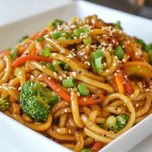 For Black Pepper Udon, you need simple yet tasty ingredients. Here&rsquo;s what you will use: - 300g udon noodles - 1 tablespoon vegetable oil - 2 cloves garlic, minced - 1 thumb-sized piece of ginger, grated - 1 red bell pepper, thinly sliced - 1 cup broccoli florets - 1 medium carrot, cut into matchsticks (julienned) - 3 green onions, chopped into small pieces These ingredients create a base that delivers flavor and texture. The udon noodles are chewy and satisfying. The vegetables add crunch and color. Seasonings bring this dish to life. Use these key flavors: - 2 tablespoons soy sauce - 1 tablespoon oyster sauce - 1 teaspoon freshly ground black pepper (adjust to taste) - 1 teaspoon sesame oil Soy sauce and oyster sauce add a rich umami taste. The black pepper gives the dish a spicy kick. Sesame oil rounds out the flavors with its nutty notes. Garnishes add a finishing touch. Consider these options: - 1 tablespoon sesame seeds (for garnish) Sesame seeds add a wonderful crunch. They also make the dish look more appealing. You can add other garnishes like sliced chili or a sprinkle of cilantro for more flavor. {{ingredient_image_2}} First, cook the udon noodles. Follow the package instructions closely for best results. Usually, this takes about 5-7 minutes. Once they are soft, drain them well. Make sure they do not stick together. I like to toss them with a little oil to keep them loose. Grab a large skillet or wok and heat 1 tablespoon of vegetable oil on medium-high. When the oil shimmers, add 2 cloves of minced garlic and 1 thumb-sized piece of grated ginger. Stir them for 1-2 minutes. Keep an eye on them so they don&rsquo;t burn. Next, toss in 1 red bell pepper, thinly sliced, 1 cup of broccoli florets, and 1 medium carrot, cut into matchsticks. Stir-fry these for 3-4 minutes. The veggies should be bright and slightly soft. Now it&rsquo;s time to bring it all together. Add the cooked udon noodles to the skillet. Pour in 2 tablespoons of soy sauce, 1 tablespoon of oyster sauce, and 1 teaspoon of freshly ground black pepper. Toss everything well, ensuring the noodles are coated in the sauce. Drizzle 1 teaspoon of sesame oil over the top. Give it another toss to mix the flavors. Finally, fold in 3 chopped green onions. This adds a fresh taste. Serve the noodles hot, topped with 1 tablespoon of sesame seeds for a nice crunch. To get the best udon texture, cook the noodles just right. Follow the package instructions closely. Overcooked noodles become mushy. Drain them well to avoid stickiness. A quick rinse with cold water can help too. This keeps them firm and ready for stir-frying. Black pepper is key in this dish. Adjust the amount based on your taste. If you love spice, add more. You can also mix in a dash of chili oil for extra heat. If you prefer a sweeter dish, try adding a bit of sugar or honey. This balances the flavors nicely and makes the dish pop. Serving is all about the look. Use deep bowls for a nice presentation. Place the noodles in the center, then layer the veggies on top. A sprinkle of sesame seeds adds crunch and style. Don&rsquo;t forget the green onions; they add color and freshness. Serve hot, and enjoy the beautiful dish you've created! Pro Tips Adjust the Spice Level: If you prefer a milder dish, reduce the amount of black pepper or skip the additional pepper altogether. You can always add more spice later! Vegetable Variations: Feel free to swap out the vegetables based on what you have on hand or your preferences. Snow peas, bok choy, or snap peas work great in this recipe! Cooking Noodles Perfectly: Be sure to rinse the cooked udon noodles under cold water after draining to stop the cooking process and prevent them from becoming mushy. Garnishing for Flavor: Consider adding fresh herbs like cilantro or basil on top before serving for an extra burst of freshness and flavor! {{image_4}} You can switch out vegetables in Black Pepper Udon. For a fresh twist, try using snap peas or bok choy. Zucchini adds a nice crunch. If you want more color, add yellow bell pepper. Mushrooms provide a hearty texture. Feel free to mix and match based on what you have. Just keep the cooking time in mind to avoid overcooking. Adding protein makes this dish even better. Chicken works well; just slice it thin. Cook it first in the skillet, then set it aside. Tofu is a great choice for a plant-based option. Use firm tofu, and saut&eacute; it until golden. Shrimp or beef can also add great flavor. Adjust the cooking time based on the protein you choose. If you need a gluten-free option, choose rice noodles instead of udon. They cook quickly, so watch them closely. Check sauces as well; many soy sauces contain gluten. You can find gluten-free soy sauce or use tamari. This way, you can enjoy a tasty dish without worry. To keep your black pepper udon fresh, let it cool first. Use an airtight container to store it. Place it in the fridge. It stays good for up to three days. Make sure to keep the noodles separate from the sauce if possible. This helps them stay tender. When you're ready to eat leftovers, you can reheat them easily. Use a skillet over medium heat. Add a splash of water or broth to keep it moist. Stir gently until heated through. You can also use a microwave. Heat in short bursts and stir in between. This helps to warm it evenly. You can freeze black pepper udon if you want to save it for later. Place cooled noodles in a freezer-safe bag. Press out the air and seal it tight. They will last up to three months in the freezer. To eat, thaw in the fridge overnight. Reheat as described above. Black Pepper Udon is a tasty noodle dish. It features thick udon noodles coated in a spicy sauce. I use fresh vegetables like bell peppers and broccoli. The dish gets its kick from black pepper. It is simple to make and packs a flavorful punch. Yes, you can use other noodles. Rice noodles or soba noodles work well too. Just be sure to adjust the cooking time. Each type of noodle has a different texture and taste. Feel free to experiment with what you like best. To make it spicier, add more black pepper. You can also include chili flakes or fresh chilies. Stir in some sriracha or chili paste for an extra kick. Just remember to taste as you go. This way, you can find the perfect heat level for you! We&rsquo;ve covered how to make delicious black pepper udon from scratch. You learned about the main ingredients, seasonings, and optional garnishes. I shared step-by-step instructions and tips for perfecting texture and flavor, along with variations and storage info. You can create many versions of this dish to suit your taste. Remember, cooking is all about fun and creativity! Enjoy trying this udon recipe and make it your own.