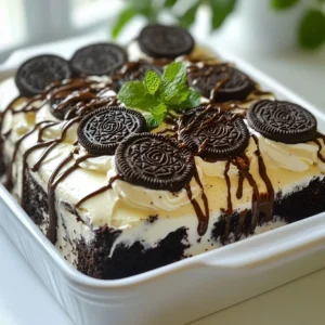 - 2 packs of Oreo cookies (regular or double stuffed) - 2 cups heavy whipping cream - 1 cup powdered sugar - 1 teaspoon vanilla extract - 1 cup chocolate syrup - 1 cup crushed Oreos (for garnish) - Fresh mint leaves (for decoration, optional) Quality matters! For Oreos, I suggest using double stuffed for a richer flavor. When choosing heavy cream, look for brands with a high fat content. This helps create a rich and fluffy whipped cream. You can make this cake fit your needs. Use gluten-free Oreos if needed. If you prefer a dairy-free version, try coconut whipped cream. For added flair, top with fresh berries or drizzle caramel sauce over the cake. You could also add crushed nuts for a nice crunch. Feel free to get creative! Each variation can give your Chocolate Oreo Icebox Cake a new twist. {{ingredient_image_2}} To start, you need to make the whipped cream. In a large mixing bowl, combine 2 cups of heavy whipping cream, 1 cup of powdered sugar, and 1 teaspoon of vanilla extract. Using an electric mixer, beat the mixture on high speed for about 3 to 5 minutes. You want to whip it until stiff peaks form. This means the cream holds its shape well when you lift the whisk. If you see it start to look fluffy and thick, you’re almost there! Use a large bowl and a whisk attachment for the best results. This helps mix the cream evenly and quickly. Now, let’s layer the cake! Grab an 8x8 inch baking dish. You will need to dip each Oreo cookie into 1 cup of chocolate syrup. Just give each cookie a quick dunk on both sides. You don’t want them soaked, just lightly coated. Begin by placing the dipped Oreos in a single layer at the bottom of your dish. Make sure to cover the bottom completely. After that, carefully spread an even layer of the whipped cream mixture over the Oreos. Use a spatula to smooth it out. Next, repeat the layering process. Add another layer of dipped Oreos followed by more whipped cream. Keep layering until you run out of either Oreos or whipped cream. The last layer should always be whipped cream for a nice finish. Chilling is key for this cake! Once you’re done layering, cover the dish tightly with plastic wrap. Place it in the refrigerator for at least 4 hours. For best taste, chill it overnight. This step allows the cookies to soften and the flavors to mix. When you’re ready to serve, sprinkle the top with crushed Oreos. You can also add fresh mint leaves for a pop of color and freshness. Cut the cake into squares and serve it chilled. A drizzle of extra chocolate syrup can make it look even better! If you over-whip the cream, it can turn grainy. To fix this, gently fold in a little more heavy cream to smooth it out. Watch your mixing speed to avoid this problem. To avoid soggy cookies, don't soak the Oreos in chocolate syrup. Just a quick dip is enough. This keeps them crisp and adds a nice flavor. For even layers, use a spatula to spread the whipped cream smoothly. Make sure each layer of cookies is flat and aligned. This makes your cake look neat and tasty. To achieve a polished finish, smooth the top layer of whipped cream carefully. A clean spatula helps here. For a final touch, sprinkle crushed Oreos evenly on top. Prep your ingredients in advance to save time. You can measure the cream and sugar before starting. This makes the workflow smooth and quick. To save more time, chill the cake overnight. This allows the flavors to blend well. Plus, it makes cutting the cake easier when it’s firm. Pro Tips Tip for Whipped Cream: Make sure to use chilled heavy cream for better whipping results. Cold cream whips up faster and achieves a better texture. Tip for Layering: For a more decadent flavor, consider adding a layer of chocolate ganache between the Oreo and whipped cream layers. Tip for Dipping Oreos: Don’t soak the Oreos in chocolate syrup; a quick dip on both sides is enough to add flavor without making them soggy. Tip for Presentation: Before serving, lightly dust the top with cocoa powder for an elegant finish, in addition to the crushed Oreos. {{image_4}} You can switch up the Oreo flavor to create fun twists. Try using mint Oreos for a refreshing touch. Birthday cake Oreos add a festive feel, while peanut butter Oreos give a nutty kick. To enhance flavors, consider adding a splash of liqueur like Kahlua or Irish cream. You can also mix in a drop of almond extract or orange zest for an extra layer of taste. If you want a vegan option, use coconut cream instead of heavy cream. You can find dairy-free Oreos, which work great in this recipe. For gluten-free needs, look for gluten-free Oreo brands. Just make sure to check the labels carefully to ensure they fit your diet. While crushed Oreos are classic, you can get creative here. Try adding chocolate shavings, sprinkles, or fresh fruit like strawberries or raspberries. In summer, berries shine bright, while in fall, a sprinkle of cinnamon or nutmeg brings warmth. These simple changes can make your cake feel new and exciting. To keep your Chocolate Oreo Icebox Cake fresh, store it in the fridge. Place any leftovers in an airtight container. If you do not have one, wrap the dish tightly with plastic wrap. This keeps the cake moist and flavorful. Make sure to seal it well to prevent any air from getting in. In the fridge, this cake will stay fresh for about four to five days. You can freeze this cake if you have leftovers. To freeze, first cut the cake into individual squares. This makes it easier to thaw later. Wrap each piece tightly with plastic wrap. Then, place the wrapped pieces in a freezer-safe bag. This will help keep the cake fresh for about one to two months. When you are ready to enjoy it again, take it out of the freezer. Allow it to thaw in the fridge for several hours. This helps keep the texture and flavor intact. Freezing may make the whipped cream a bit softer, but the chocolate and Oreo flavors will still shine. Enjoy your delicious treat anytime! The Chocolate Oreo Icebox Cake lasts about 3 to 4 days in the fridge. Keep it covered to avoid drying out. Check for signs of spoilage, like an off smell or changes in texture. If it looks or smells strange, it's best to throw it away. Yes, you can make this cake ahead of time. I recommend preparing it a day in advance. This allows the flavors to blend well and the cookies to soften. The cake tastes even better when chilled overnight. If you need an alternative to heavy whipping cream, try coconut cream or whipped coconut milk. Both options are dairy-free and great for vegan diets. You can also use a store-bought non-dairy whipped topping. Just make sure it fits your dietary needs. This blog post guides you through making a delicious Chocolate Oreo Icebox Cake. We covered the key ingredients, explained step-by-step whipping and layering, and shared useful tips and tricks. With variations for dietary needs, you'll find options that work for everyone. Remember to chill your cake well for the best flavor. Enjoy your baking adventure! You now have all the tools to impress with this simple, tasty dessert. Go make your chocolate dream a reality!