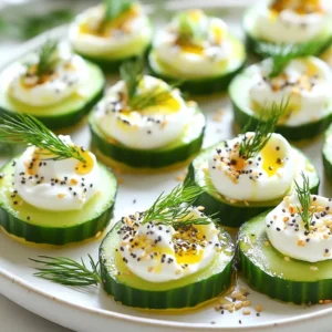 - 2 large cucumbers - 8 oz cream cheese, softened to room temperature - 1 cup Greek yogurt - 2 teaspoons fresh lemon juice - 1 tablespoon fresh dill, finely chopped - 1 tablespoon fresh chives, finely chopped - 1 tablespoon sesame seeds - 1 tablespoon poppy seeds - 1 teaspoon garlic powder - 1 teaspoon onion powder - Salt and freshly ground black pepper, to taste - Everything bagel seasoning (store-bought or homemade) You can swap the cream cheese for vegan cream cheese. This keeps it dairy-free. Greek yogurt can also change. Use a dairy-free yogurt if needed. For a lighter touch, low-fat cream cheese works well, too. If you don&rsquo;t have fresh herbs, you can use dried ones. Just reduce the amount, as dried herbs are more potent. Fresh herbs bring life to your bites. If you want to try something new, add fresh parsley or basil. These herbs add a unique twist. For more zing, consider adding a pinch of cayenne pepper. It gives a nice kick without overpowering the dish. You can even mix in some chopped sun-dried tomatoes for an added burst of flavor. {{ingredient_image_2}} Start by washing the cucumbers. Use cold water to clean them well. This step helps remove dirt and keeps them fresh. Next, slice the cucumbers into 1-inch thick rounds. Aim for even slices to make them look nice. Place the rounds on a clean kitchen towel to soak up extra moisture. This helps prevent sogginess later. In a medium bowl, mix the softened cream cheese and Greek yogurt. Add two teaspoons of fresh lemon juice for a bright taste. Next, stir in the chopped dill and chives. These herbs add a fresh flavor. Then, sprinkle in garlic powder, onion powder, salt, and pepper. Blend everything until smooth and creamy. A spatula or hand mixer works great here. Now, it&rsquo;s time to fill the cucumber slices. Use a piping bag or a zip-lock bag with a corner snipped off. Pipe a generous dollop of the cream cheese mixture onto each cucumber round. Make sure to create little mounds for a nice look. In a small bowl, mix together sesame seeds, poppy seeds, and everything bagel seasoning. Sprinkle this mixture on top of the filled cucumber slices. This gives them a great crunch. Finally, arrange your cucumber bites on a platter. Garnish with extra sprigs of dill or chives for a lovely finish. Cutting cucumbers correctly makes a big difference. Here are some tips to make it easy: - Choose the Right Cucumber: Use firm, fresh cucumbers. English cucumbers work well since they have fewer seeds. - Wash Thoroughly: Rinse cucumbers under cold water to clean them. This removes dirt and pesticides. - Cut with Care: Use a sharp knife for clean cuts. Slice cucumbers into 1-inch thick rounds. - Avoid Sogginess: Place cut slices on a towel to absorb extra moisture. This keeps the bites crisp. Your filling should be smooth and rich. Here&rsquo;s how to make it perfect: - Use Room Temperature Cream Cheese: Let the cream cheese sit out for about 30 minutes. This helps it blend well. - Mix Well: Combine cream cheese and Greek yogurt in a bowl. Add lemon juice, dill, and chives. - Blend Smoothly: Use a spatula or mixer to blend until creamy. No lumps should remain. - Season to Taste: Add garlic powder, onion powder, salt, and pepper. Adjust flavors as needed for your taste. How you serve your bites matters. Here are some ways to make them shine: - Use a Pretty Platter: Arrange cucumber bites on a colorful platter. This makes them pop. - Add Garnishes: Top bites with extra dill or chives for a fresh look. - Keep it Cool: Serve bites cold or at room temperature. This enhances the flavors. - Layer with Lettuce: Line the platter with fresh lettuce. This adds color and freshness to the display. Pro Tips Choose the Right Cucumbers: For the best flavor and crunch, opt for English cucumbers, which have fewer seeds and a thinner skin compared to regular cucumbers. Make-Ahead Option: You can prepare the cream cheese mixture a day in advance. Just assemble the bites right before serving to keep the cucumbers crisp. Customize Your Seasoning: Feel free to add your favorite herbs or spices to the cream cheese mixture, such as dill, parsley, or even a hint of hot sauce for a kick. Serving Suggestions: These bites pair wonderfully with a variety of beverages, making them perfect for parties or gatherings. Serve with a selection of dips for variety. {{image_4}} You can easily enhance these cucumber bites with some tasty additions. Consider adding chopped olives for a briny kick. You can also include diced sun-dried tomatoes for a sweet touch. If you like heat, try adding a pinch of red pepper flakes. Each of these options adds a new layer of flavor that makes your bites even more exciting. You don&rsquo;t have to stick with plain cream cheese. You can use flavored cream cheese for a twist. Try garlic or herb cream cheese for extra zest. You could also experiment with a spicy jalape&ntilde;o cream cheese. These small changes will give your bites a unique spin that everyone will enjoy. Seasonal ingredients can make your cucumber bites shine. In spring, add fresh radishes for a crunch. In summer, consider topping them with ripe tomatoes. In fall, roasted pumpkin seeds can add a nutty flavor. For winter, sprinkle some pomegranate seeds for a festive look. These variations will keep your appetizer fresh and fun all year round! To keep your Everything Bagel Cucumber Bites fresh, store them properly. Place any leftover bites in an airtight container. This helps prevent them from drying out. Use a layer of parchment paper between layers if you stack them. This layer stops the toppings from getting smushed. Keep the container in the fridge. This keeps the bites crisp and cool. When stored correctly, cucumber bites stay fresh for about 2 to 3 days. After that, they may lose their crunch. You might notice the cucumbers releasing water, affecting the texture. Always check for any signs of spoilage before serving leftovers. If they smell funny or look slimy, it&rsquo;s best to toss them. Freezing cucumber bites is not the best choice. Cucumbers contain a lot of water. When frozen, they become mushy when thawed. If you want to prepare ahead, consider freezing the cream cheese mixture instead. You can pipe it onto fresh cucumber slices later. This way, you maintain texture and flavor. Yes, you can prepare Everything Bagel Cucumber Bites ahead of time. You can make the cream cheese mixture a day before. Store it in the fridge. Slice the cucumbers on the day you plan to serve. This keeps them fresh and crunchy. Just pipe the filling onto the cucumbers and add seasoning when ready. This method saves time and keeps flavors bright. I love serving Everything Bagel Cucumber Bites on a colorful platter. You can pair them with fresh veggies or crackers. Adding a dip, like hummus or ranch, can boost flavor. A sprig of dill or chives on top adds a nice touch. These bites work well at parties or casual get-togethers. They look great and taste even better! To make Everything Bagel Cucumber Bites healthier, swap regular cream cheese with a low-fat version. You can also use all Greek yogurt for a lighter filling. Adding more fresh herbs can boost flavor without extra calories. Feel free to reduce the amount of seasoning if you want to cut sodium. These simple changes keep the bites delicious and nutritious. These Everything Bagel Cucumber Bites are easy to make and tasty. We covered the key ingredients, including substitutions and added flavors. You learned how to prepare cucumbers, create a creamy mix, and assemble everything. We also shared tips for cutting, filling, and presenting your bites perfectly. Finally, we discussed storage options to keep them fresh. Enjoy experimenting with variations for any occasion. Have fun impressing your friends with these delicious appetizers!