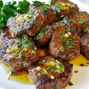 - 1 lb sirloin steak - 4 tablespoons unsalted butter - 4 cloves garlic - Fresh herbs (rosemary and thyme) For this recipe, sirloin steak is your star. It is tender and full of flavor. The butter adds richness, while garlic gives a punch. Fresh herbs like rosemary and thyme enhance the taste. - Salt and pepper - 1 tablespoon olive oil Salt and pepper are key. They boost the steak's natural taste. Olive oil helps sear the meat. This ensures a nice crust while keeping it juicy inside. - Fresh parsley Fresh parsley brightens the dish. It adds color and a fresh note. A sprinkle on top makes your steak bites look great. Using these ingredients, you'll create a dish full of flavor. Each element plays a role in making your garlic butter steak bites delicious and satisfying. {{ingredient_image_2}} 1. Start by seasoning the sirloin steak pieces with salt and pepper. This step boosts the meat's flavor. Make sure to coat each piece evenly. 2. Next, heat a large skillet over medium-high heat. Add the olive oil and let it shimmer. This means the oil is hot but not smoking. 1. Carefully place the seasoned steak bites into the skillet. Arrange them in a single layer. If the skillet is small, cook them in batches. This allows them to brown well. 2. Sear the steak bites for about 2-3 minutes on each side. Flip them only once. For medium-rare, aim for an internal temp of 130°F (54°C). 1. Once the steak bites are cooked, move them to a plate to rest. 2. In the same skillet, lower the heat to medium. Add the unsalted butter. As it melts, add minced garlic, rosemary, and thyme. Stir gently for 1-2 minutes. Watch closely to keep the garlic from burning. 3. Return the steak bites to the skillet. Toss them in the garlic butter sauce. Let them warm for another minute. 4. Finally, serve the garlic butter steak bites on a platter. Garnish with chopped parsley for a fresh touch. Choosing the right cut of steak For garlic butter steak bites, I recommend using sirloin steak. It has great flavor and tenderness. Cuts like ribeye or tenderloin work too, but they are pricier. Look for steak with good marbling. This will keep the meat juicy. Importance of resting the meat Resting the meat is key. After cooking, let the steak bites sit for a few minutes. This helps the juices redistribute, making each bite more flavorful. If you skip this step, the juices run out, and the steak can be dry. Batch cooking for even browning Cook the steak bites in batches if needed. Overcrowding the pan will cause steaming instead of browning. I sear them in a single layer. This gives a nice crust that locks in flavor. Adjusting cooking times based on preferences Cooking times vary based on your desired doneness. For medium-rare, aim for 2-3 minutes per side. Use a meat thermometer to check the internal temperature. It should be about 130°F or 54°C for medium-rare. Presentation ideas for parties For a fun twist, skewer the steak bites on toothpicks. This makes them easy to grab at parties. You can also serve them on a colorful platter. Add some roasted veggies for a vibrant look. Pairing with sides and beverages Garlic butter steak bites pair well with many sides. Try mashed potatoes or a fresh salad. For drinks, a robust red wine complements the flavors nicely. If you prefer non-alcoholic, a sparkling water with lemon works great too. Pro Tips Resting the Meat: Allow the steak bites to rest after cooking for at least 5 minutes. This helps retain juices and ensures a more tender bite. Choosing the Right Pan: Use a heavy-bottomed skillet or cast iron pan for better heat retention and even cooking. Fresh Herbs: Opt for fresh herbs whenever possible; they enhance the flavor significantly compared to dried herbs. Don’t Overcrowd the Pan: Sear the steak bites in batches if necessary. Overcrowding can lead to steaming instead of browning. {{image_4}} If you want to switch up your garlic butter steak bites, try different cuts of steak. Here are some great alternatives to sirloin: - Ribeye: This cut is juicy and flavorful. - Filet mignon: It’s tender and cooks quickly. - Flank steak: A lean option that absorbs flavors well. Cooking times vary by cut. Ribeye may take about 3-4 minutes per side for medium-rare. Filet mignon needs about 2-3 minutes per side. Flank steak cooks in about 4-5 minutes per side. Always check with a meat thermometer for the best results. You can add a kick to your steak bites by including spicy elements. Here are some ideas: - Red pepper flakes: Just a pinch can add heat. - Jalapeños: Fresh or pickled, they bring a nice zing. Herbs also enhance the flavor. Besides rosemary and thyme, consider these: - Oregano: It adds a lovely earthiness. - Basil: This herb provides a sweet touch. Feel free to mix and match herbs and spices to find your favorite flavor. Making garlic butter steak bites fit your diet is easy. To make it gluten-free, simply ensure your steak is free from gluten-based marinades. Use fresh herbs instead of dried ones if you prefer. For low-carb modifications, skip any high-carb sides. Serve with a salad or steamed veggies instead. This way, you enjoy a delicious meal that fits your needs. Store leftover garlic butter steak bites in an airtight container. This keeps them fresh and tasty. Place them in the fridge right after they cool down. They can stay good for up to three days. If you want them to last longer, freezing is a great option. To reheat steak bites, you can use a skillet or microwave. For the skillet, warm it on medium heat. Add a small amount of butter or oil to keep them moist. Cook for a few minutes, stirring gently. If using a microwave, place them in a bowl and cover. Heat in short bursts, checking often to avoid overcooking. This will help keep the bites juicy. You can freeze garlic butter steak bites for up to three months. First, let them cool completely. Then, place them in a freezer-safe bag or container. Make sure to remove as much air as possible. When you’re ready to cook, thaw them overnight in the fridge. For quick cooking, you can also cook them straight from frozen, just add a few extra minutes to the cooking time. The best way to cook steak bites is to sear them in a hot skillet. Here are some tips to get it right: - Use sirloin steak for great flavor and tenderness. - Cut the steak into even bite-sized pieces. - Season the pieces with salt and pepper before cooking. - Preheat your skillet with olive oil until it shimmers. - Cook the steak bites in a single layer. - Sear for 2-3 minutes on each side for a nice crust. - Use a meat thermometer to check for doneness. Aim for 130°F for medium-rare. - Let the steak rest before serving to keep it juicy. Yes, you can use different methods to cook steak bites. Here are some alternatives: - Grilling: Cook the steak bites on a hot grill for that smoky flavor. - Air frying: This method gives crispy bites with less oil. Set the air fryer to 400°F and cook for 8-10 minutes. - Oven roasting: Toss the steak bites with oil and herbs. Roast them at 400°F for about 15 minutes, flipping halfway through. Serving garlic butter steak bites with the right sides makes the meal even better. Here are some great options: - Roasted vegetables: Carrots, broccoli, or bell peppers add color and nutrients. - Mashed potatoes: Creamy potatoes pair well with the rich steak flavor. - Rice or quinoa: These can soak up the garlic butter sauce. - Salad: A fresh salad adds crunch and balance to the meal. - Toothpicks for appetizers: Skewering the bites makes for easy serving at parties. In this post, we explored the process of making delicious garlic butter steak bites. We covered ingredients like sirloin steak, fresh herbs, and butter. I shared step-by-step instructions for preparing, cooking, and making the sauce. We also discussed tips for perfecting flavor and suggested fun serving ideas. Cooking steak bites at home is easy and rewarding. Enjoy experimenting with different cuts and flavors to make each dish unique. Happy cooking!