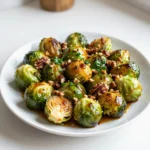 To make Balsamic Honey Roasted Brussels Sprouts, you need these key items: - 1 lb Brussels sprouts, trimmed and halved - 3 tablespoons balsamic vinegar - 2 tablespoons honey - 2 tablespoons olive oil - 1 teaspoon garlic powder - ½ teaspoon salt - ¼ teaspoon freshly ground black pepper These ingredients blend together to create a sweet and tangy flavor. The Brussels sprouts become tender and caramelized, making each bite delightful. You can enhance your dish with these optional ingredients: - ¼ cup chopped pecans or walnuts for added crunch - Fresh parsley, finely chopped, for garnish The nuts add a great texture, while parsley brightens the dish with color. If you don’t have certain ingredients, don’t worry! Here are some easy swaps: - Use maple syrup instead of honey for a vegan option. - Swap balsamic vinegar for apple cider vinegar for a different taste. - Replace olive oil with avocado oil for a lighter flavor. These substitutions keep the dish tasty while fitting your needs. Enjoy experimenting! {{ingredient_image_2}} Start by preheating your oven to 400°F (200°C). This temperature is key for cooking the Brussels sprouts. It helps them get crispy on the outside while staying tender inside. Preheating also makes sure that the roasting happens evenly. Next, grab a large mixing bowl. In this bowl, mix together 3 tablespoons of balsamic vinegar, 2 tablespoons of honey, and 2 tablespoons of olive oil. Add 1 teaspoon of garlic powder, ½ teaspoon of salt, and ¼ teaspoon of black pepper. Whisk these ingredients well until they blend into a smooth mixture. This mix gives your Brussels sprouts a sweet and tangy flavor, which is truly delicious. Now, take 1 pound of trimmed and halved Brussels sprouts. Place them in the bowl with your balsamic honey mixture. Gently toss until each sprout is well coated. This step is important to ensure every bite is packed with flavor. Once coated, prepare a baking sheet lined with parchment paper. Spread the Brussels sprouts in a single layer on this sheet. This helps them roast evenly and keeps them from sticking. It’s time to roast! Place your baking sheet in the preheated oven. Roast the Brussels sprouts for 25-30 minutes. Make sure to stir them halfway through cooking. This ensures they brown evenly. They are ready when they turn golden brown and feel tender when pierced with a fork. The caramelization enhances their natural sweetness, making them even more tasty. Once roasted, carefully take the baking sheet out of the oven. Let the Brussels sprouts cool for a couple of minutes. If you want to add some crunch, sprinkle ¼ cup of chopped pecans or walnuts during the last 5 minutes of roasting. This gives a nice texture contrast. Finally, garnish with freshly chopped parsley. This adds a pop of color and freshness to your dish! When picking Brussels sprouts, look for bright green, firm ones. They should feel heavy in your hand. Avoid any with yellow leaves or soft spots. Small to medium-sized sprouts are sweeter. Big ones can taste bitter. To make sure your Brussels sprouts roast evenly, cut them in half. This helps them cook all the way through. Toss them well in the balsamic honey mix. Make sure every piece is coated. Spread them out on the baking sheet. Give them space! If they are too close, they will steam instead of roast. Stir them halfway through cooking to help with even browning. You can cook Brussels sprouts in an air fryer for a quick option. Set it to 375°F (190°C) and cook for about 15-20 minutes. Shake the basket halfway through. For stovetop cooking, use a large skillet. Add oil and heat it over medium heat. Sauté the sprouts until they are tender and caramelized, about 10-15 minutes. Pro Tips Choose Fresh Brussels Sprouts: Select Brussels sprouts that are firm and tightly closed for the best flavor and texture. Adjust Sweetness: Depending on your taste, you can adjust the amount of honey used for a sweeter or more tangy flavor profile. Experiment with Seasonings: Feel free to add your favorite herbs or spices to the balsamic mixture, like thyme or rosemary, for an extra layer of flavor. Serve Immediately: For the best texture and flavor, serve the Brussels sprouts right after roasting, while they are still warm and crispy. {{image_4}} If you want to switch things up, try using maple syrup or agave nectar. Both add natural sweetness. They also bring their own unique flavor to the dish. If you prefer a lower-calorie option, use stevia or coconut sugar. These will still give you a nice glaze. Just remember, each sweetener has a different taste, so adjust to your liking. Spices can enhance the taste of your Brussels sprouts. Consider adding smoked paprika for a smoky touch or cayenne for heat. A sprinkle of cumin gives a warm, earthy flavor that pairs well with balsamic. You can also try adding fresh herbs like thyme or rosemary. They add a bright note that complements the sweetness of the honey. Experiment with different combinations to find what you love best. Balsamic honey roasted Brussels sprouts make a great side dish. They pair well with grilled chicken or roasted pork. Serve them alongside a hearty grain like quinoa or farro for a balanced meal. For a festive touch, add them to a holiday feast. Garnish with toasted nuts for crunch and fresh parsley for color. This will impress your guests and elevate your dish. After enjoying your Balsamic Honey Roasted Brussels Sprouts, store leftovers in an airtight container. Keep them in the fridge. They will stay fresh for up to three days. Make sure they cool down before sealing the container. This helps avoid moisture buildup, which can make them soggy. To reheat, use an oven or air fryer. Preheat the oven to 350°F (175°C). Spread the Brussels sprouts on a baking sheet. Heat them for about 10-15 minutes. This will keep them crispy. If using an air fryer, set it to 350°F (175°C) and cook for about 5-7 minutes. Avoid using the microwave, as it can make them mushy. You can freeze Brussels sprouts if you want to store them longer. First, roast them as per the recipe. After cooling, place them in a freezer-safe bag. Remove as much air as possible before sealing. They can last for up to three months in the freezer. When ready to eat, thaw them in the fridge overnight before reheating. Yes, you can prepare the Brussels sprouts ahead. Trim and halve them, then toss with the balsamic mixture. Store them in the fridge for up to 24 hours. When you're ready, roast them as usual. This saves time and keeps the flavor. To make this dish vegan, simply replace honey with maple syrup or agave nectar. Both options provide sweetness without animal products. The other ingredients are already vegan-friendly. These Brussels sprouts pair well with many dishes. They complement roasted chicken, grilled steak, or baked salmon beautifully. You can also serve them with quinoa or rice for a hearty meal. Their sweet and tangy flavor balances savory foods nicely. To reduce bitterness, choose fresh, bright green Brussels sprouts. Trim off any yellow leaves and cut them in half. Roasting them with balsamic and honey caramelizes their natural sugars. This makes them taste sweeter and less bitter. If you still find them bitter, try soaking them in cold water for 10 minutes before cooking. This article guided you through making Balsamic Honey Roasted Brussels Sprouts. We covered the necessary ingredients and their substitutes. You learned step-by-step instructions for the best cooking methods. Tips on selecting sprouts and alternative cooking methods gave added insight. We explored fun variations and storage tips for leftovers. In summary, this dish is easy and delicious. Enjoy making it your own and impressing friends with your culinary skills.